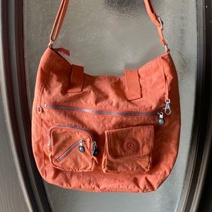 Kipling orange crossbody, convertible. Active wear, mulipocket and dividers